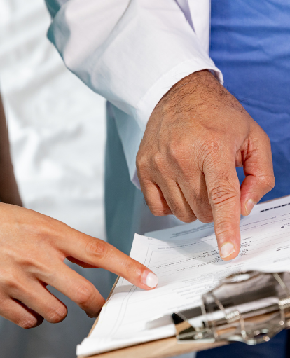 Photo of two healthcare providers looking at a chart